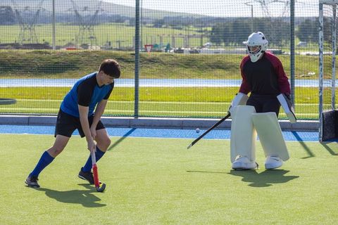 Field Hockey Competitors Playing Match on Synthetic Turf