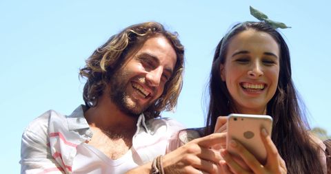 Happy Couple Enjoying Sunny Day with Smartphone - Download Free Stock Images Pikwizard.com