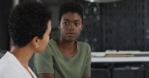 Two Diverse Businesswomen Engaging in Office Discussion