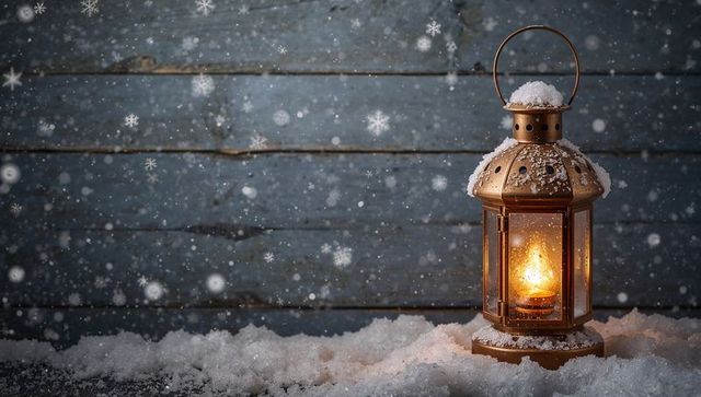 Glowing antique lantern emitting warm flame on snow with rustic blue wood background