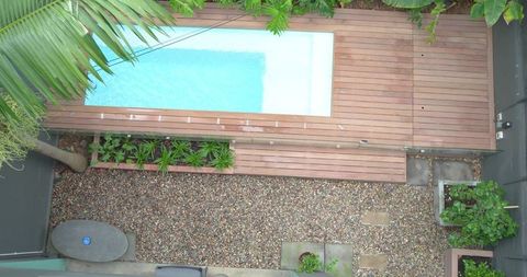Rectangular plunge pool on timber deck in compact private courtyard, overhead aerial view