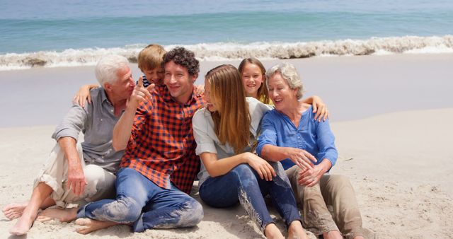 Smiling Multigenerational Family Relaxing on Beach on Sunny Day - Download Free Stock Images Pikwizard.com