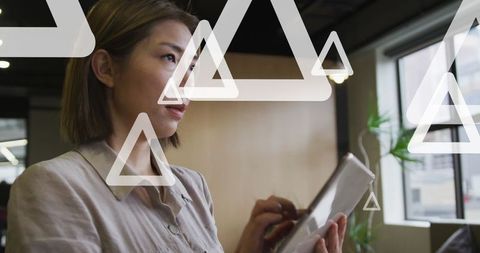 Professional Woman Using Tablet with Geometric Overlays