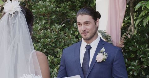 Groom Reading Vows Outdoors During Wedding Ceremony
