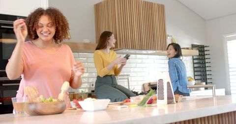 Diverse Friends Preparing Healthy Salad in Modern Kitchen
