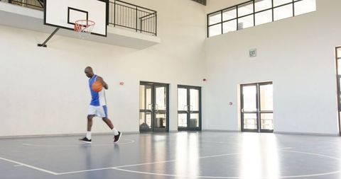 Athlete Practicing Basketball Dribbling on Indoor Court