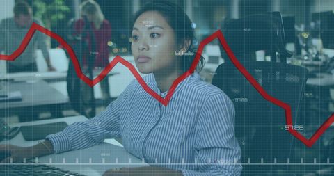 Focused businesswoman analyzing declining financial graph in office