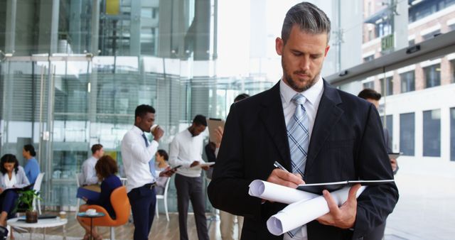 Businessman Making Notes During Busy Office Meeting - Download Free Stock Images Pikwizard.com