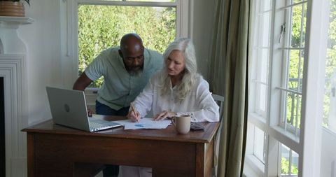 Senior Couple Collaborating on Finance Documents at Home