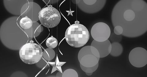 Festive christmas baubles over blurred lights