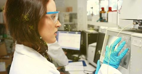 Female Laboratory Technician Operating HPLC Instrument Wearing Safety Glasses and Blue Gloves