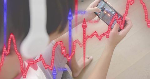 Asian man sitting on floor using smartphone for mobile trading with ar finance charts