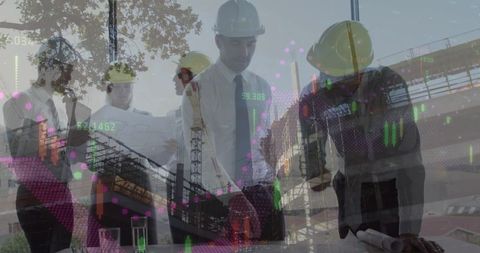 Team of architects reviewing plans at active construction site
