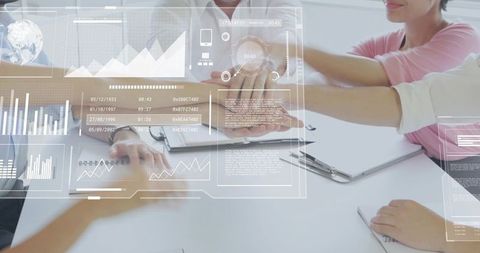 Team stacking hands over digital dashboards collaborating on business analytics and strategy