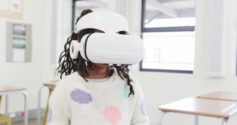 Child Engaging in Learning with Virtual Reality Headset in Classroom