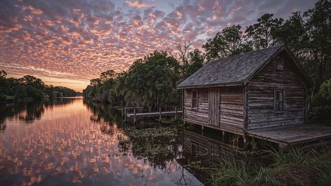 Sunset Reflection at Rustic Riverside Boathouse