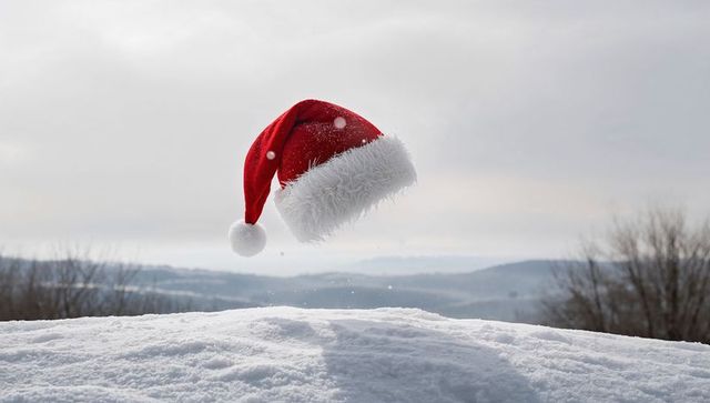 Floating Santa Hat over Snowy Field with Airborne Snow and Overcast Winter Landscape