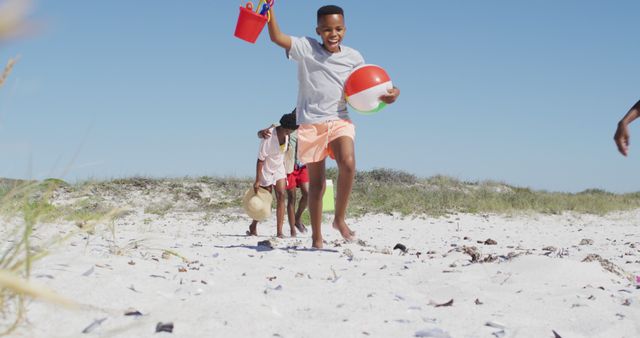 Children Playing on Sunny Beach with Toy Bucket and Ball - Download Free Stock Images Pikwizard.com