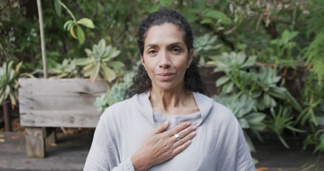 Serene Woman Meditating Outdoors with Hand on Chest - Download Free Stock Images Pikwizard.com