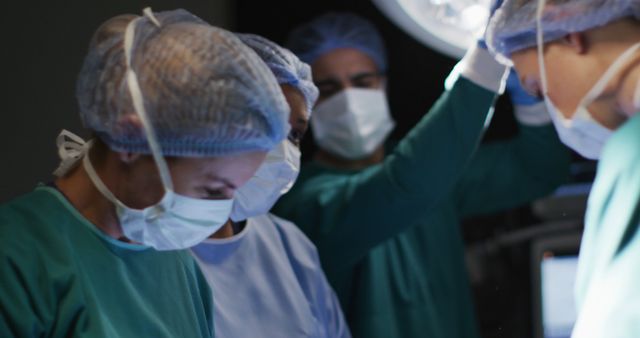 Diverse surgeons with face masks during surgery in hospital - Download Free Stock Photos Pikwizard.com