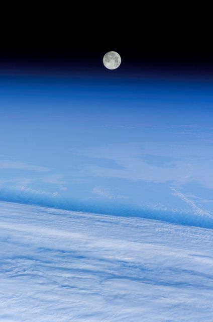 ISS012-E-19245 (12 Feb. 2006) --- A full moon is visible in this view above Earth's horizon and airglow, photographed by an Expedition 12 crewmember on the International Space Station.