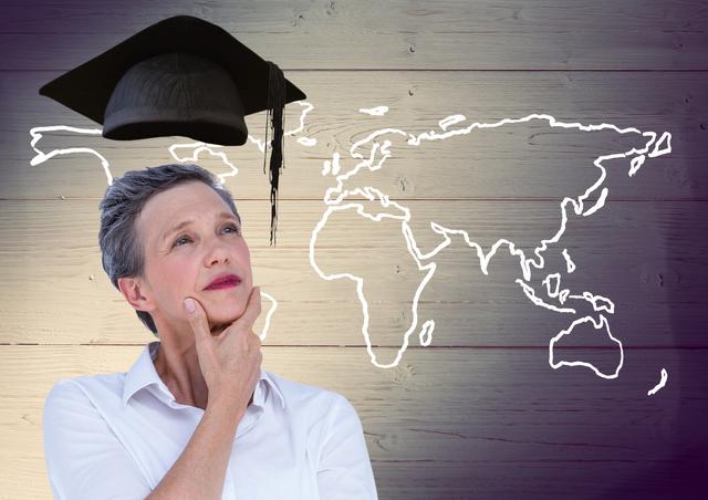 Digital composition of thoughtful woman with graduation cap and world map on wooden background
