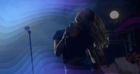 Energetic Female Lead Vocalist Performing with Diverse Band on Moody Hazy Stage Spotlight