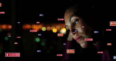 Woman by Nighttime City View with Interactive Digital Icons Illuminated