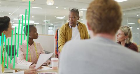 Diverse Team Discussing Business Growth with Graph Overlays