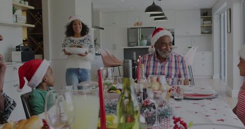 Family Celebrating Christmas Around Festive Dining Table