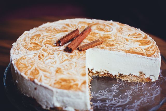 Close-up of Creamy Cinnamon Cake with Decorative Vanilla Swirls - Download Free Stock Photos Pikwizard.com