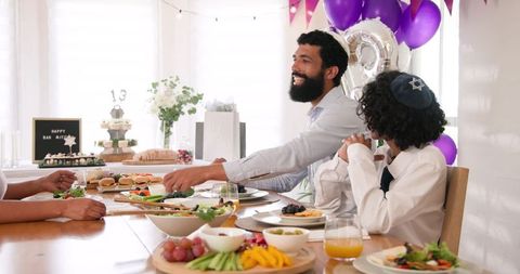 Family Celebrating Bar Mitvah with Festive Meal and Decor
