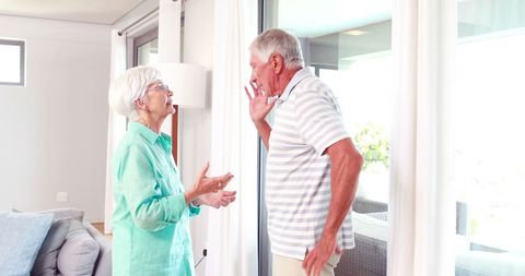 Senior couple arguing in modern living room