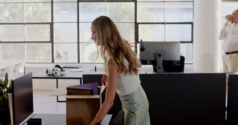 Team unpacking boxes in modern office for new workday