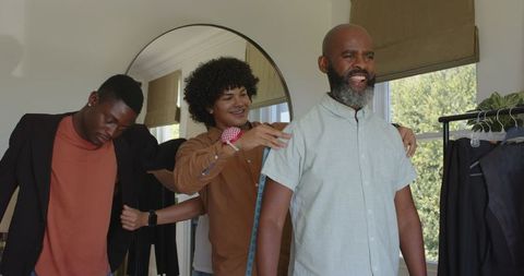 Friends preparing attire, sharing anticipation for wedding day