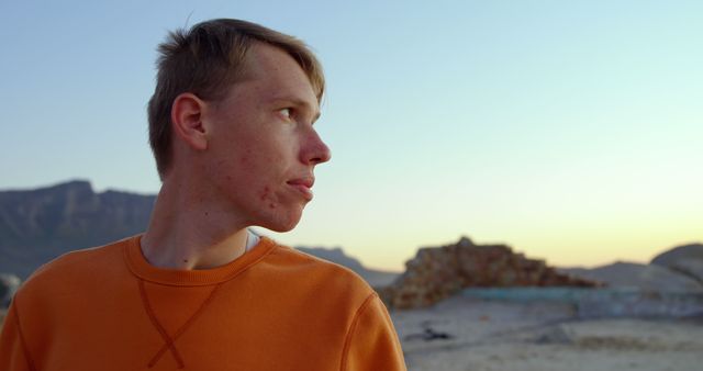 Young Man Outdoors in Desert Landscape Looking into Distance - Download Free Stock Images Pikwizard.com