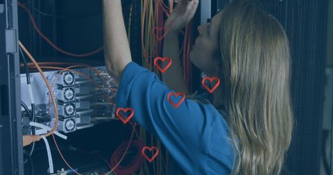 Technician managing network cables in high-tech server environment