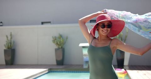 Young Woman Relaxing at Poolside with Sunhat on Sunny Day