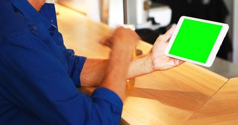 Man in Casual Attire Using Tablet at Modern Bar