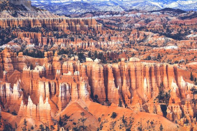 This striking view of Bryce Canyon National Park in winter showcases the park's unique red rock formations dusted with snow. The stunning landscape features intricately carved hoodoos and towering cliffs, making it a perfect destination for nature enthusiasts, hikers, and photographers. Ideal for use in travel magazines, outdoor adventure blogs, and promotional materials highlighting stunning natural scenery.