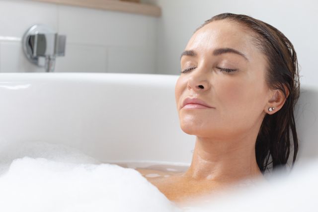 Woman relaxing in bathtub at bathroom - Download Free Stock Photos Pikwizard.com