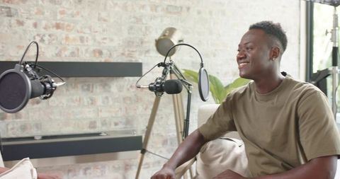 African american co-hosts recording casual daytime podcast in cozy home studio