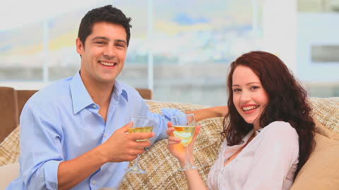 Couple Relaxing at Home with Wine Glasses in Hands