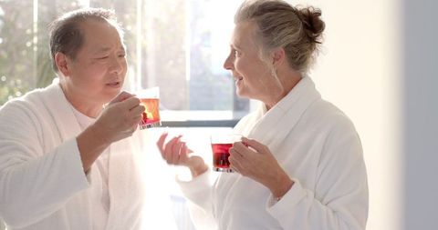 Senior couple enjoying relaxing herbal tea by sunlit window