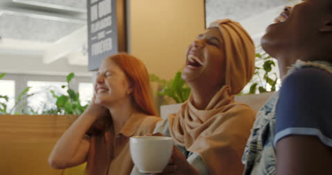 Diverse Women Laughing and Bonding Over Coffee