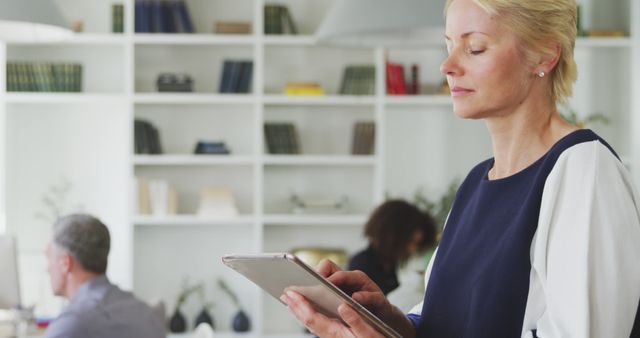 Senior Businesswoman Using Tablet in Modern Office - Download Free Stock Images Pikwizard.com