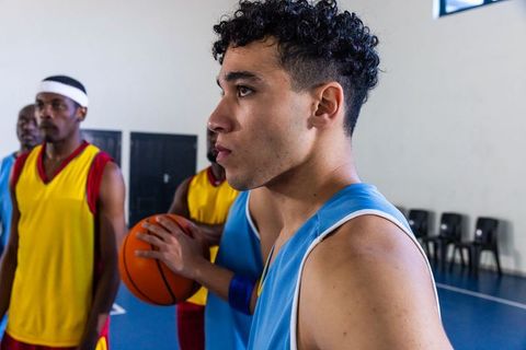 Focused Diverse Basketball Players on Indoor Court
