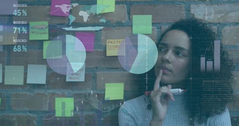 Woman Analyzing Data Visualization with Sticky Notes and Charts