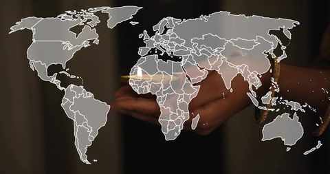 Holding iridescent orb with world map overlay, gold bracelet, global connection concept