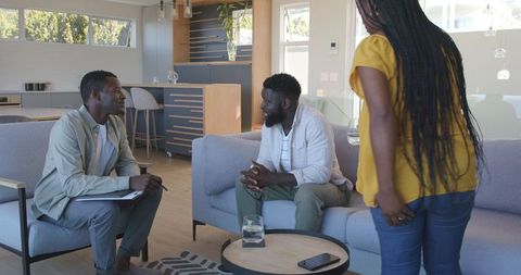 Couple consulting with advisor in modern living room